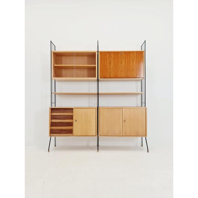 Freestanding string shelf system unit, bookcase in ash, walnut, and metal by Koch Möbel Germany, 1950s. The individual...