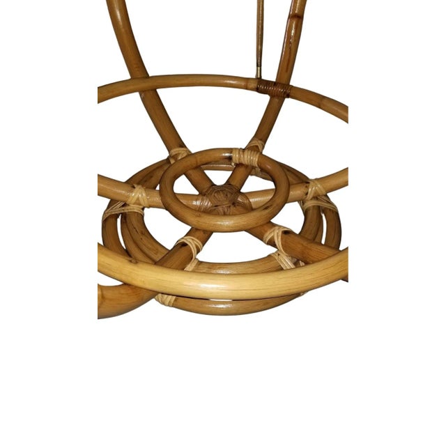 This restored round rattan table, with a Formica top, boasts a unique size and height at 23" high and 43" wide, serving as...