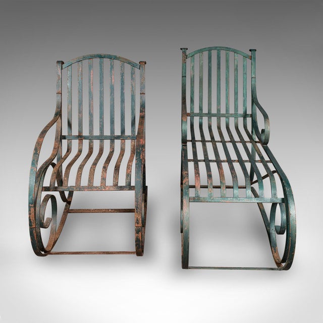 This is an antique garden lounger set. An English, wrought iron rocker and steamer chair, dating to the Edwardian period,...