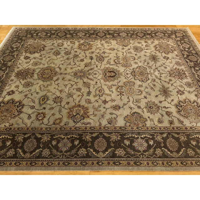 This is a Tabriz-style rug, showcasing a refined floral field with elegant palmettes and vines, framed by a deep chocolate...