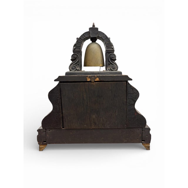 An early 20th-century American bell top mantel clock by the Gilbert Clock Company, dated 1903. This sculptural clock...