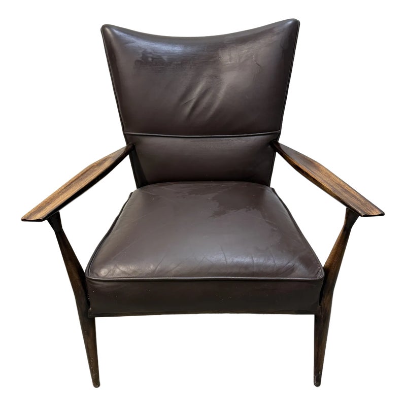 Brown leather chair with wooden arms and frame