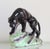 Make a bold statement with this striking 1950s Mid-Century Modern ceramic black panther sculpture, a timeless decorative...