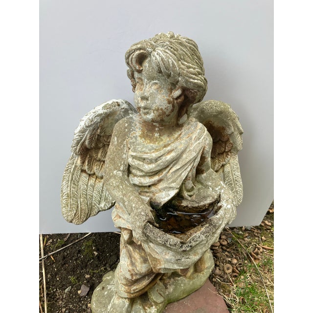 This cast cement figure has been aging in a perennial New England garden for over 35 years. The details are very defined....