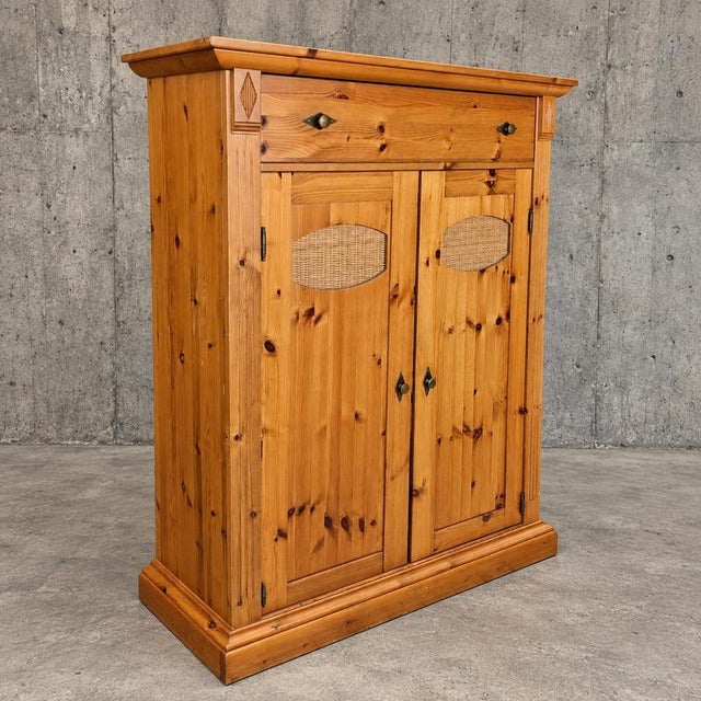 Classic pine / Meidenkast also known as a Vertiko / wicker details /This type of cabinet is traditionally characterized by...