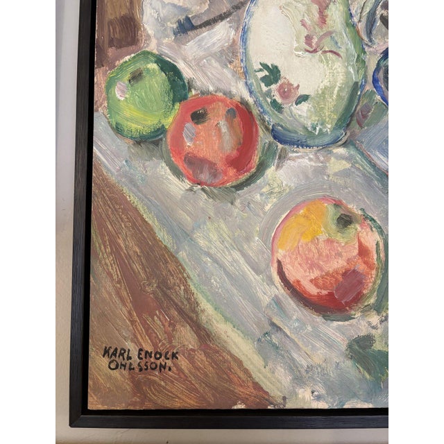 Colorful oil still life of a mixed bouquet in a painted white pitcher, with apples and grapes in a cobalt-blue footed bowl...