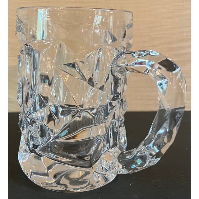A pair of Tiffany & Co. "Ice Rock" Cut Crystal Beer Mugs, which features deeply sculpted, jagged geometric facets that...