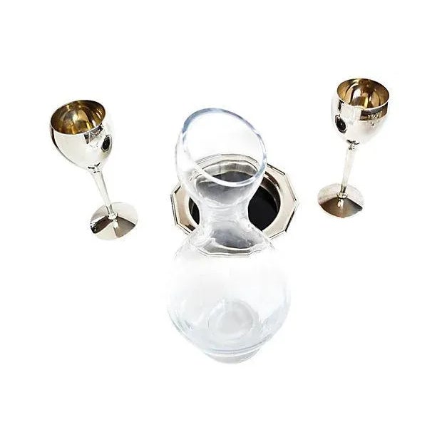Four-piece serving set including a California carafe (13"H x 5"Dia) marked "BV", a pair of silverplate wine glasses (8"H x...