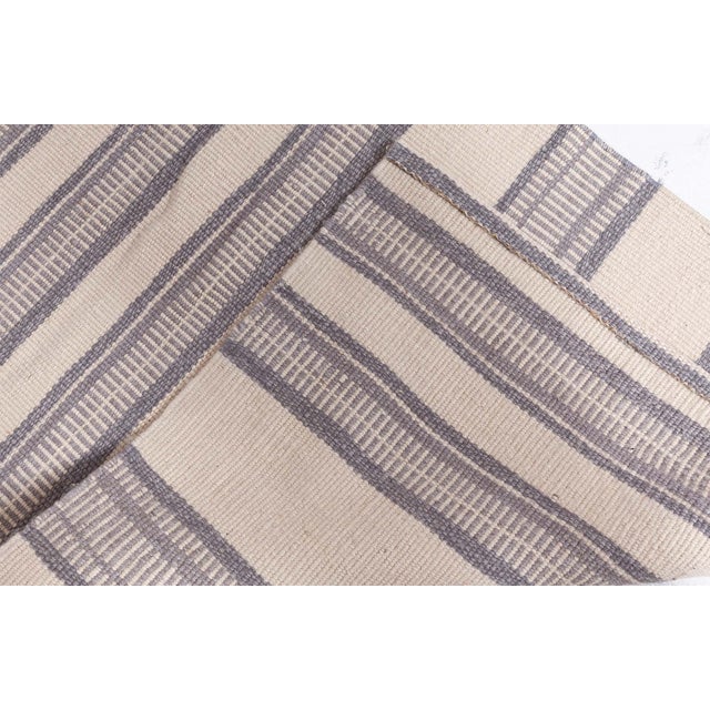 This contemporary handwoven wool runner stands out for its understated elegance and textural simplicity. Rendered in a...