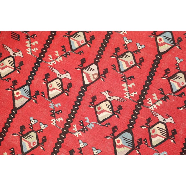 A Square Size Turkish Kilim with a geometric design on a red field from the middle of the 20th century Details rug no....