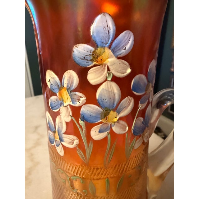This Antique Fenton Carnival Glass Pitcher with the "Forget-Me-Not" pattern is a stunning piece of vintage collectible...