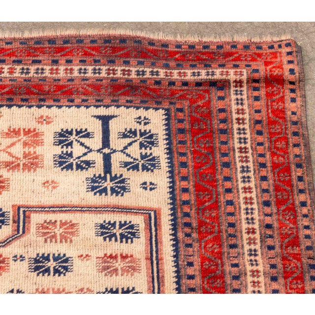 Turkish Baluch Wool Rug, in cream, red and navy blue. 5' 8" L x 3' 4" W. Provenance: From a 45 East 62nd Street Collection.
