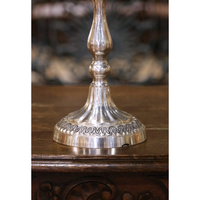 This tall and elegant French candle holder was crafted circa 1950 and cast in solid brass, finished with a rich silvered...