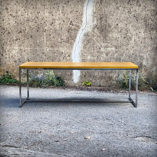 Monumental coffee table composed of an oak veneer top framed by a solid oak band, resting on a chromed steel base. This...