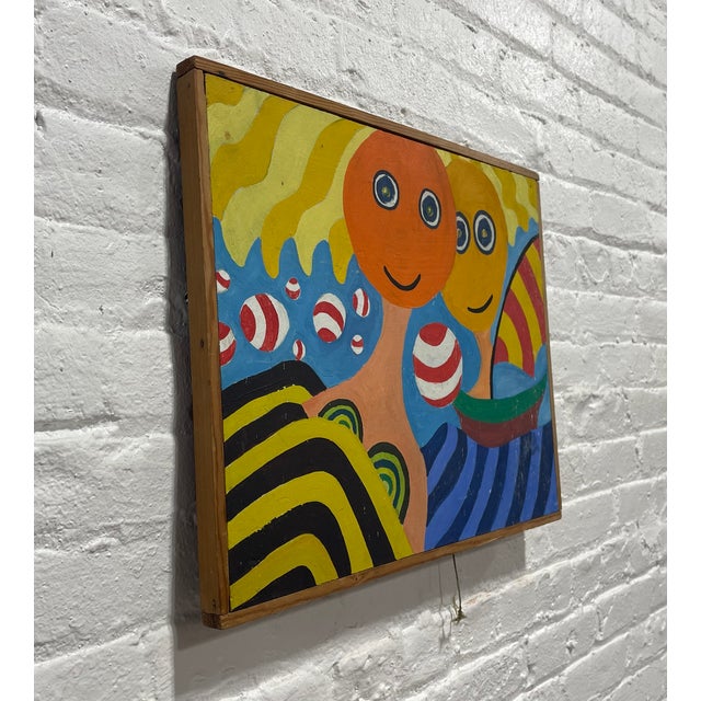 Mid Century Modern framed artwork featuring two wide-eyed figures surrounded by playful waves, striped balls and a...