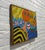 Mid Century Modern framed artwork featuring two wide-eyed figures surrounded by playful waves, striped balls and a...