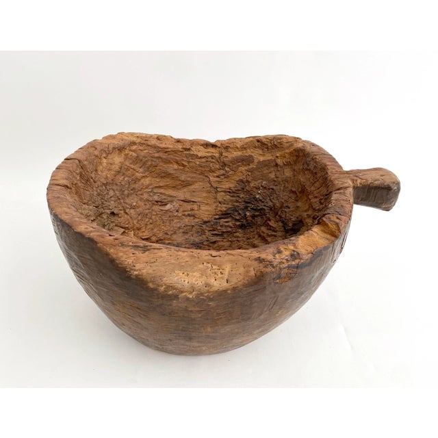 Stunning organic teak wood bowl with handle is part artisan/part Mother Nature in its free-form design. Sourced in...