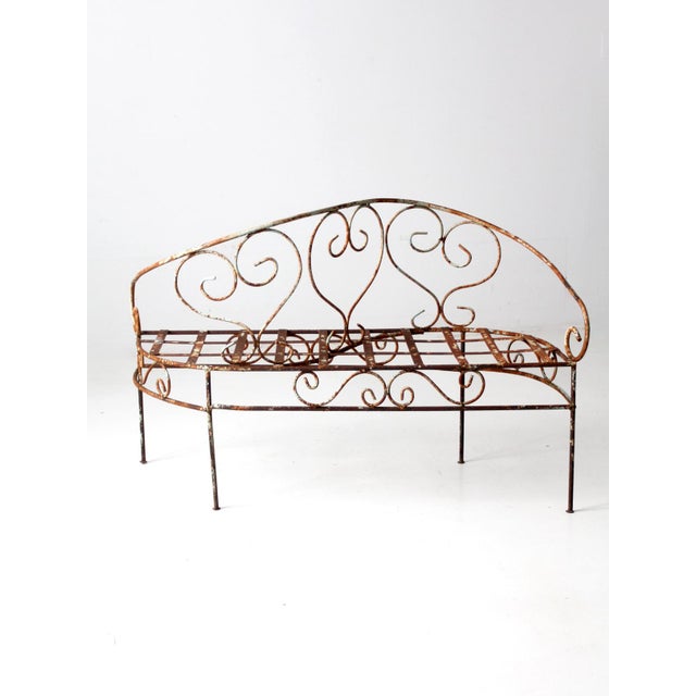 This is an antique tete-a-tete conversation garden bench. The scrolling iron bench seats back to back allowing for...