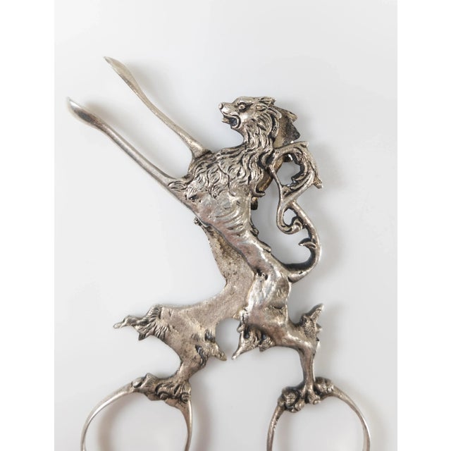 We are selling this cool pair of 19th Century German 800 marked silver tongs in the form of a Lion rampant, most likely...