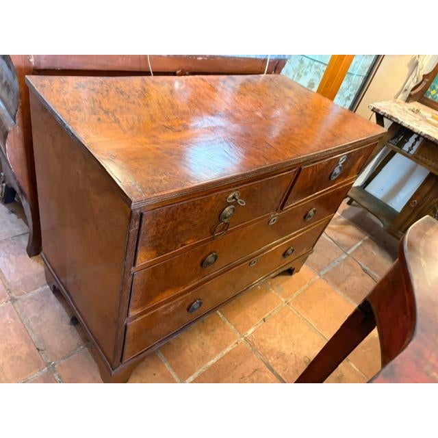 This early 1800s French Pollard Oak Chest of Drawers (Commode) is a beautifully crafted piece of antique furniture. Made...