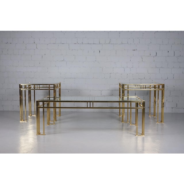 Three beautiful, high-quality vintage coffee tables in the Hollywood Regency style. All three glass tops have beveled...