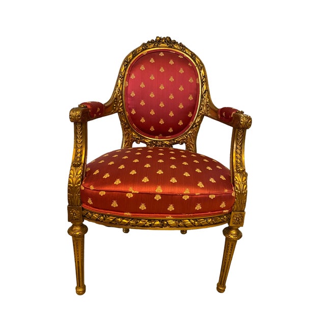 This stately pair of vintage French gilt chairs in the style of Louis the XVI feature elaborate hand carved leaf designs...