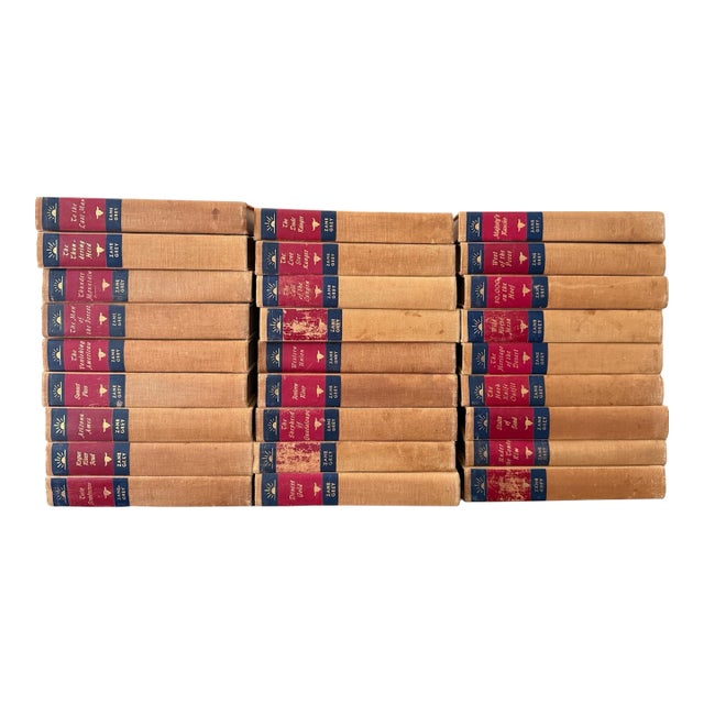 Mid-Century Set of 27 (Twenty Seven) Zane Grey Books Vintage Western Collection Tan Cloth Binding Red Blue Spine For Sale