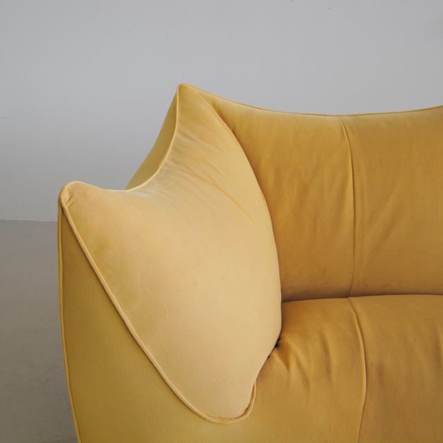 Original vintage 'BAMBOLE' sofa, with recent upholstery in mustard/yellow velvet fabric. What makes this sofa special is...