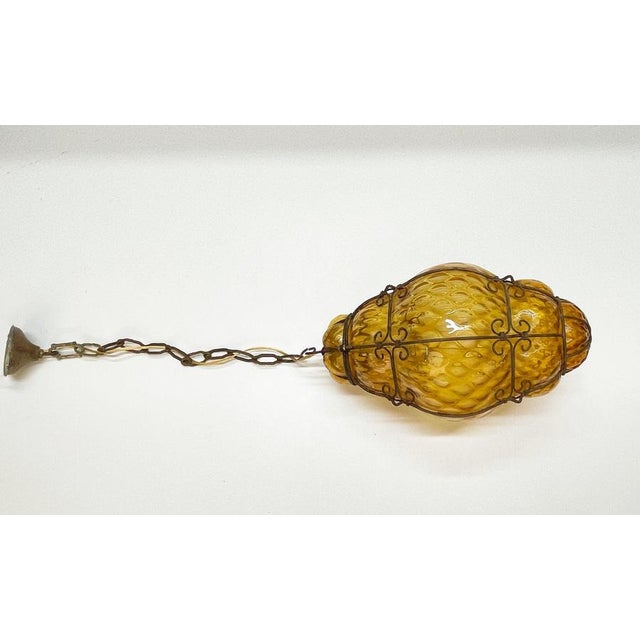 Beautiful murano glass bubble chandelier with amber glass cage. The glass is hand-blown with an amber shade and was...