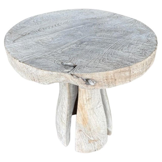 Beautiful side table featuring a thick organic ancient teak wood top and sculptural base with sleek cut outs. We added a...