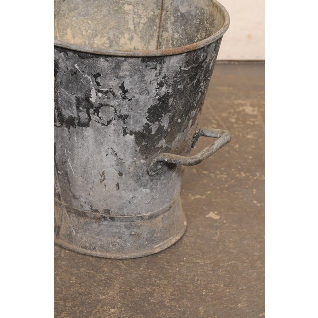 A charming French galvanized zinc bucket from the early 20th century. This antique bucket from France, features an...