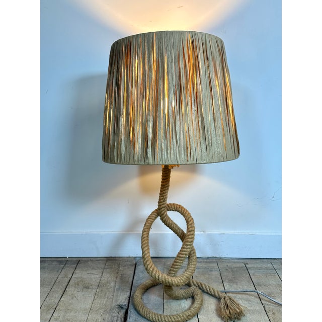 Table lamp with a rope base, wrapped and reinforced, and a raffia shade. Designed by Adrien Audoux and Frida Minet, 1950....