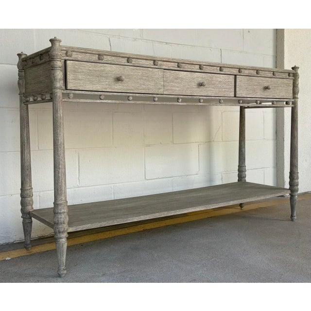 Original retail $5245, stylish Jonathan Charles Transitional Gray Oak Morris Console Table, three drawers lined in black...