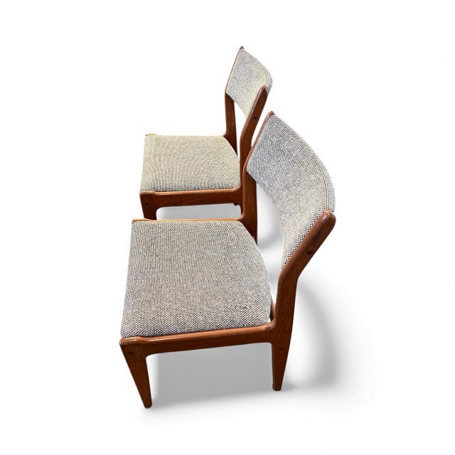 Beautiful pair of Mid-Century Modern dining chairs crafted in warm solid teak, featuring elegant sculptural frames and...