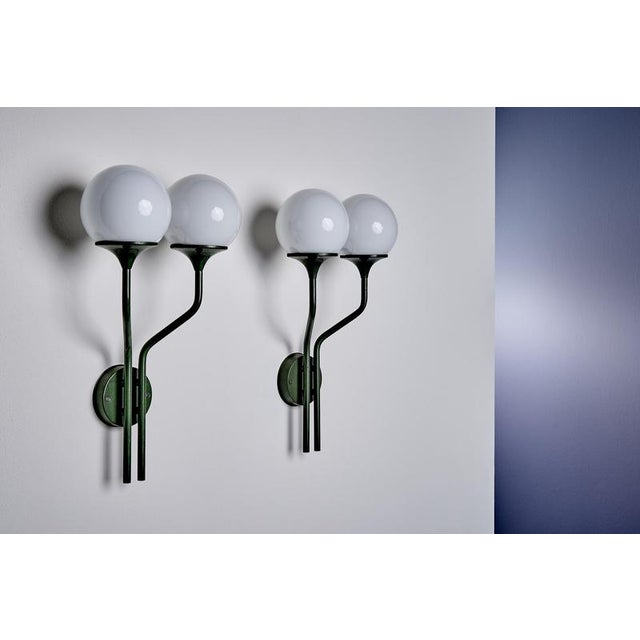 Italian mid-century wall sconce with two globes by Goffredo Reggiani for Lampadari Reggiani, Monza. The design features...