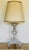 A large painted wood altar stick converted into a lamp. Decades of paint are revealed throughout the distressed surface...