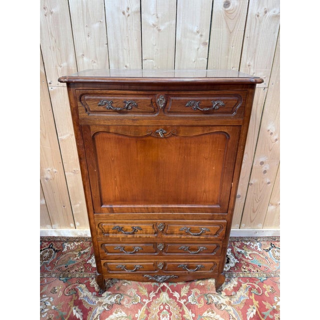 A louis xv style drop-front secretary desk, crafted from solid cherry wood, with a provincial structure dating from the...