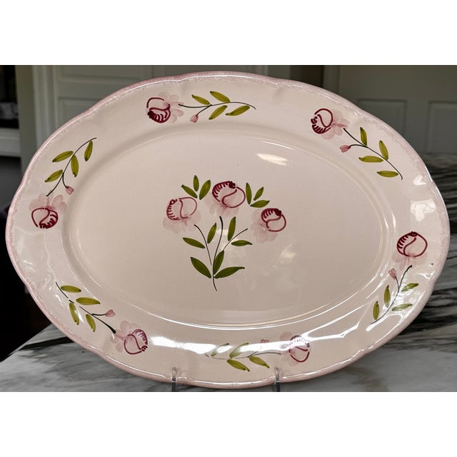 Made in Italy. Hand painted and glazed terra cotta with sponge wear motif scallop border and rose design. Peachy pink with...