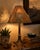 A striking piece of functional art by French-born metal artist Bernard Collin, this signed table lamp combines a hand-...