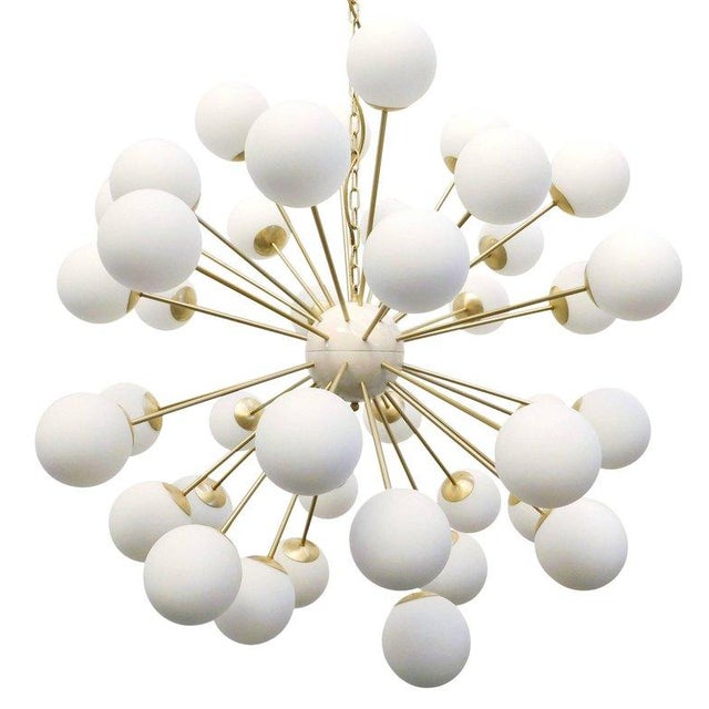 Italian sputnik chandelier with 40 matte white Murano glass globes mounted on brass frame in satin brass finish / Made in...