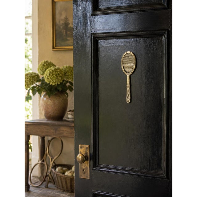 A wonderfully distinctive vintage door knocker cast in the form of a traditional tennis racket. The oval head features a...