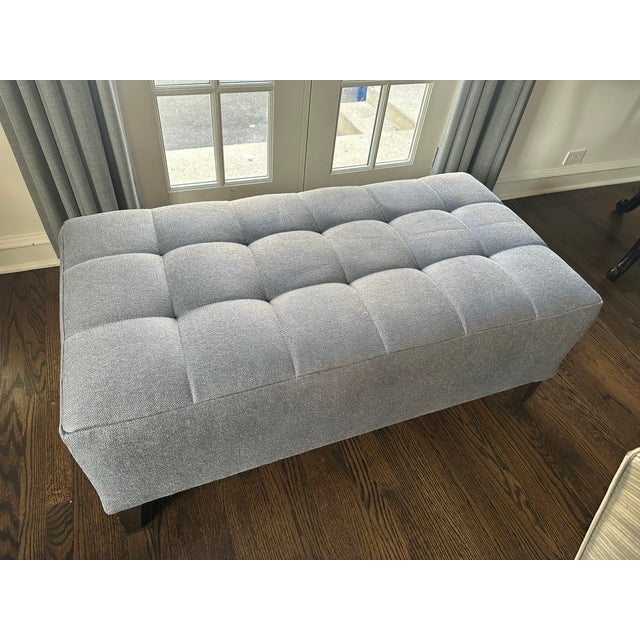 Tufted Gray Upholstered Ottoman , recently recovered, and near perfect condition Description: A sculptural tufted ottoman...