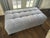 Tufted Gray Upholstered Ottoman , recently recovered, and near perfect condition Description: A sculptural tufted ottoman...