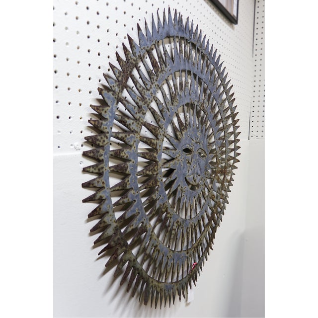 Hand-cut metal sun wall sculpture by Haitian artist Almann Ulysse (born 1945), crafted from recycled steel oil drums....