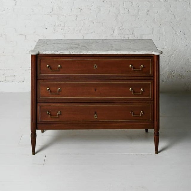 A beautifully proportioned 19th century Belgian Louis XVI mahogany chest of drawers, presenting three generous smooth-...