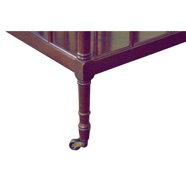 1980s wooden magazine holder with handsome brass caster feet. Center drink top in center. Spindle legs. No maker’s mark...