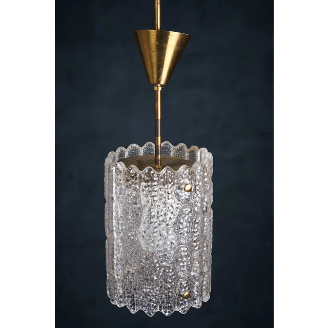 Pendant designed by Carl Fagerlund for Orrefors Sweden, 1960s. This stunning lamp is made of brass with crystal glass as...
