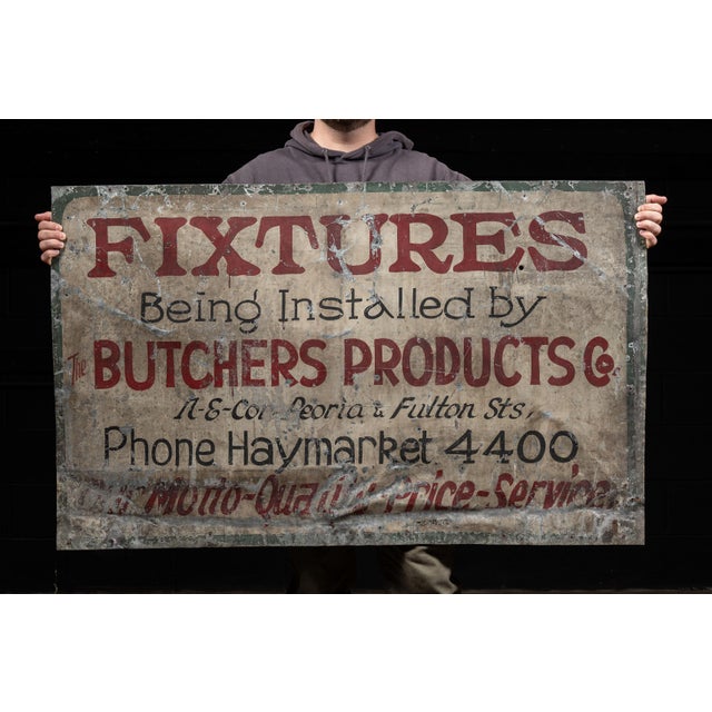 Large hand-painted tin trade sign advertising fixtures installed by The Butchers Products Co. Bold red and black lettering...