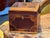 Inlaid tea caddy of canted rectangular form, the hinged lid and front centered with reserves bordered by stringing and...