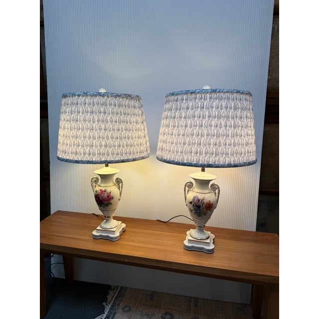 Design Plus Gallery presents a Pair of Porcelain Floral Urn Shaped Table Lamps. These sweet lamps will warm up your...